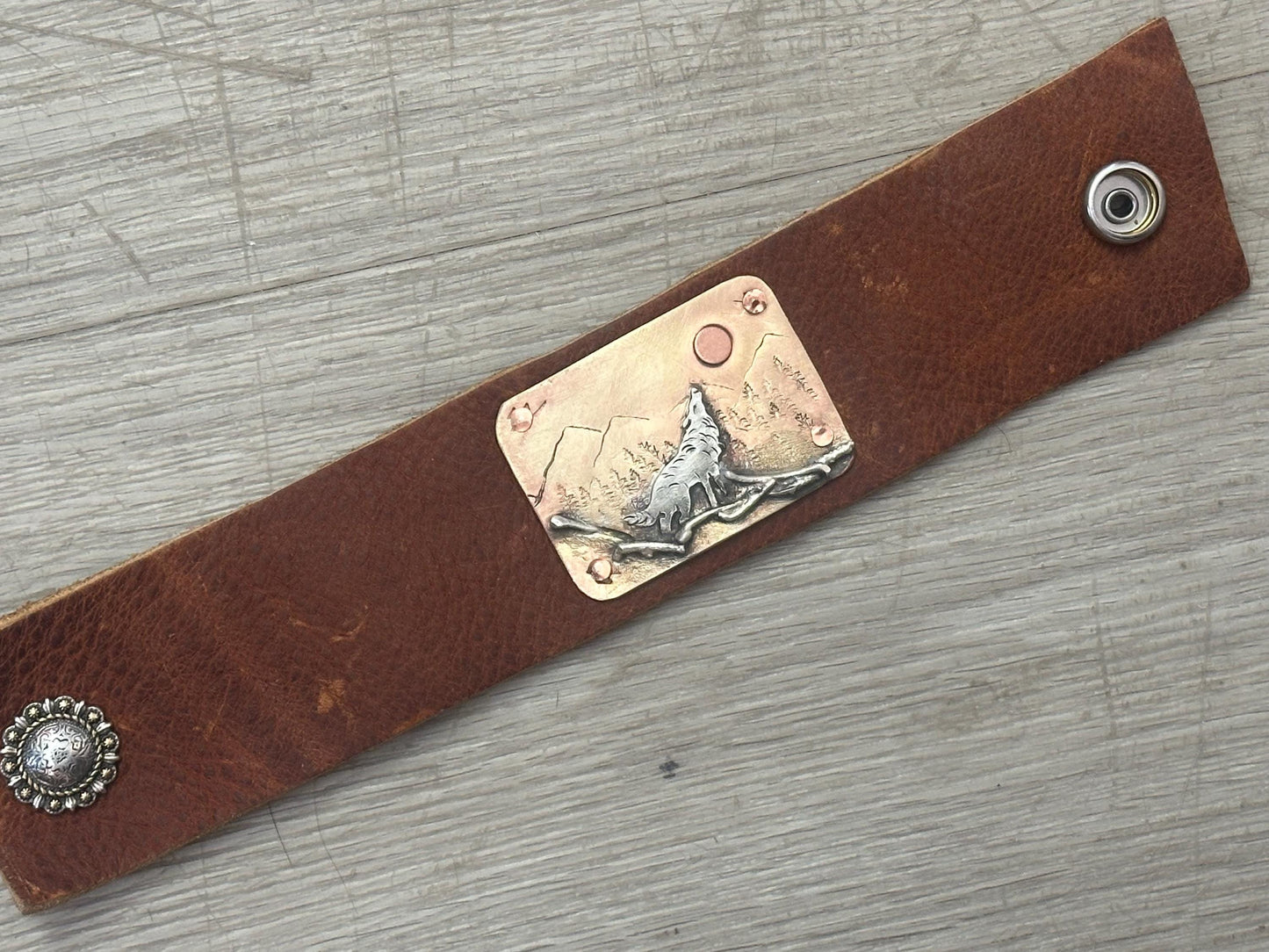 Wide rustic wolf roaming mountain cuff, old west, handcrafted metalwork, western button snap closure, western fashion