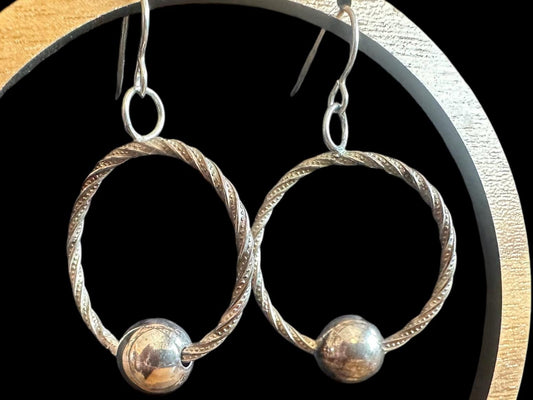 Handmade hoop earrings with free spinning silver bead