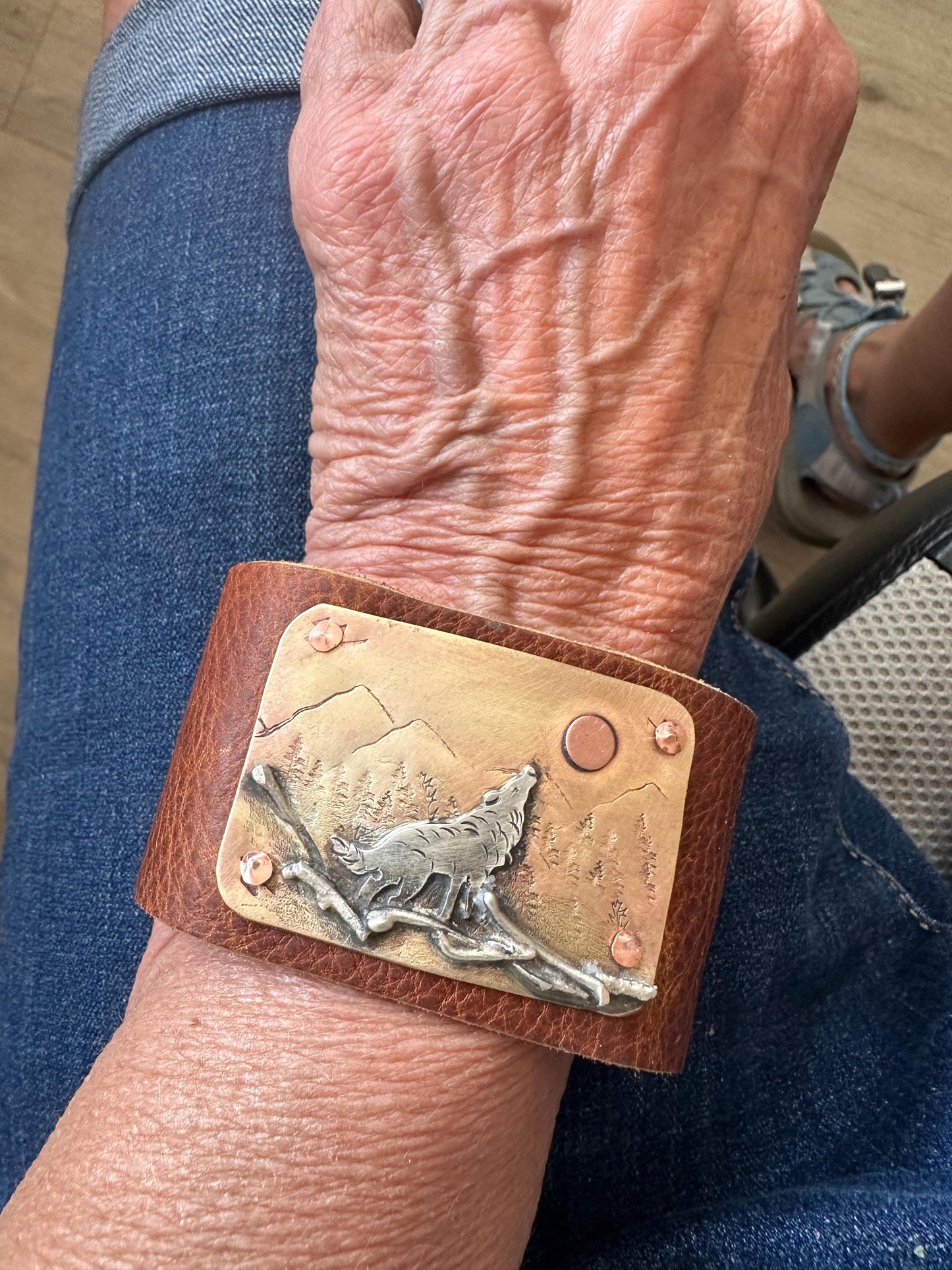 Wide rustic wolf roaming mountain cuff,  old west, handcrafted metalwork, western button snap closure, western fashion
